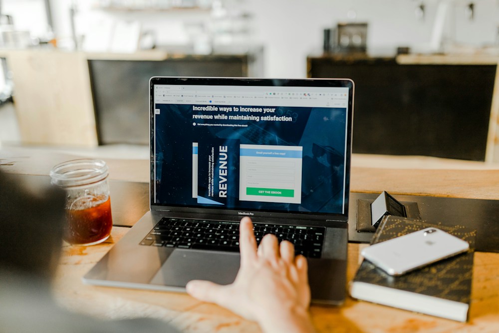 A person reading financial information on a laptop