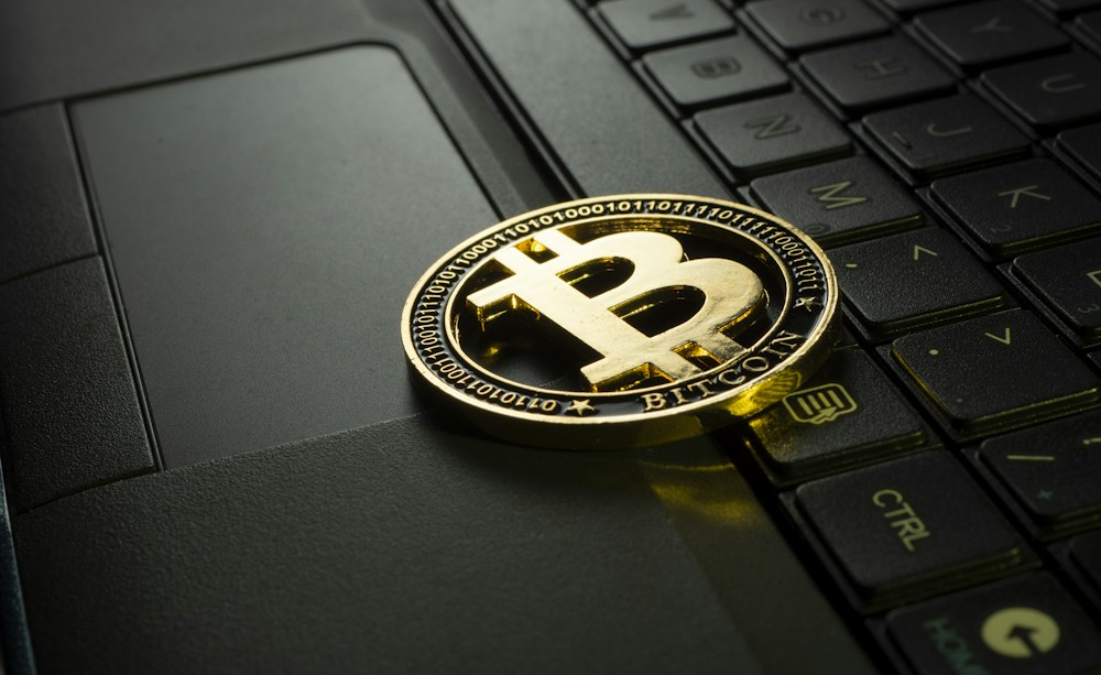 A physical cryptocurrency illustration on a laptop keyboard